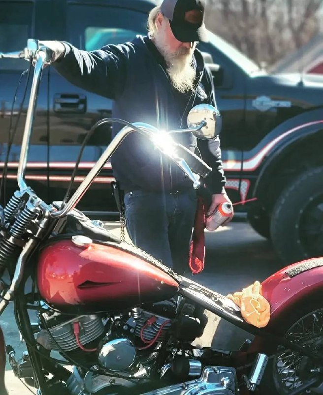 Harley-Davidson rider standing beside custom touring motorcycle